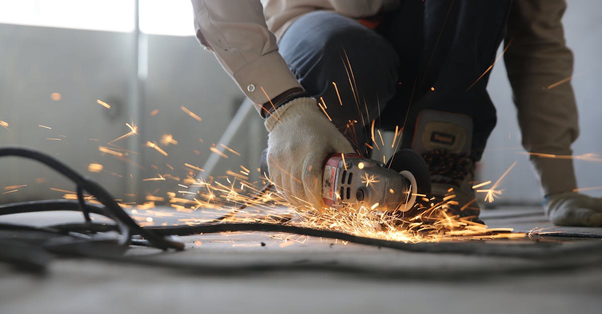 Industrial worker grinding steel